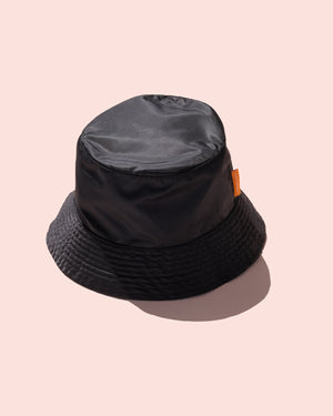 Black Fenty Beauty Bucket Hat on a pink background