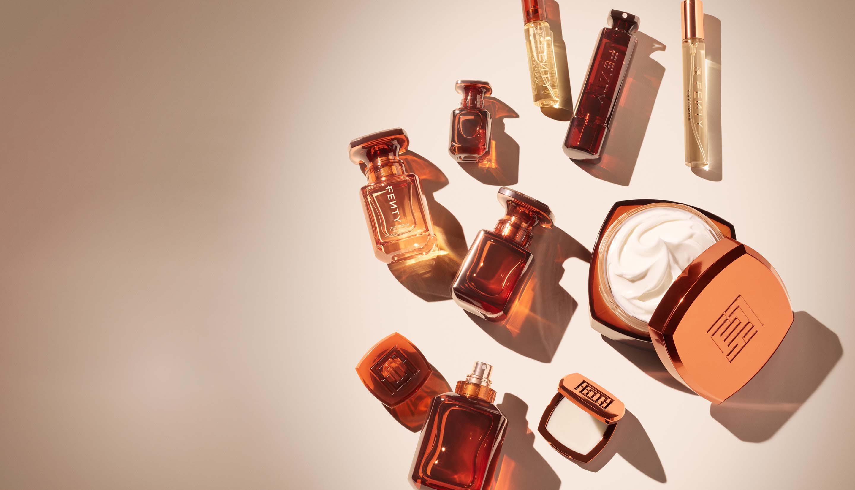 Fenty Fragrance full product assortment on a beige background.