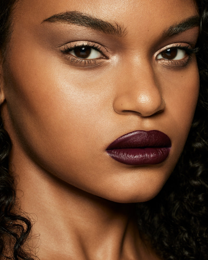 medium skin toned model wearing stunna lip paint in the shade underdawg