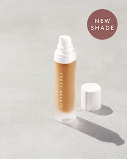 An open bottle of a new shade of Pro Filt'r Soft Matte Longwear Foundation in the shade 335 on a grey background. An open bottle of a new shade of Pro Filt'r Soft Matte Longwear Foundation in the shade 335 on a grey background.