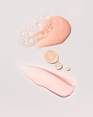 A smear of each product in the Fenty Mineral Skin Start'r Set full-size bundle on a peach background.