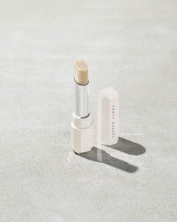 Pro Kiss'r Lip-Loving Scrubstick standing upright with the cap off and the lip scrub twisted up. Pro Kiss'r Lip-Loving Scrubstick standing upright with the cap off and the lip scrub twisted up.