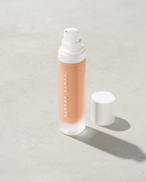 open bottle of Fenty Beauty Pro Filt'r Soft Matte Longwear Foundation with pump dispenser in shade #160 on concrete background