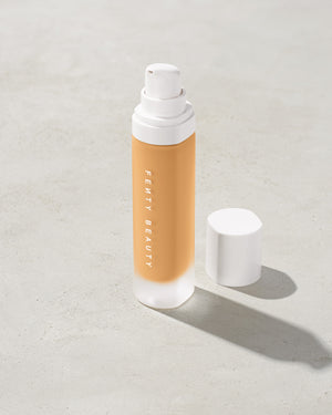 open bottle of Fenty Beauty Pro Filt'r Soft Matte Longwear Foundation with pump dispenser in shade #250 on concrete background