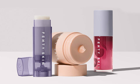 Product shot of Fenty Skin lip care collection including Lux Balm Lip Balm, Plush Puddin' Lip Mask, and Fenty Treats Lip Oil.