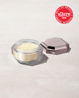 Open container of Pro Filt'r Instant Retouch Setting Powder in shade butter on a concrete background. Allure best of beauty award winner 2020 badge on the top right.