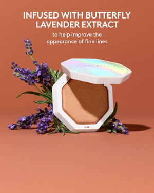 Product image of Demi'glow Light-Diffusing Highlighter with ingredient image of lavender behind open product on an orange background. Text above reads "Infused with butterfly lavender extract to help improve the appearance of fine lines.