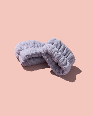 Fenty Skin Purple Cleansing Cuffs on a pink background.