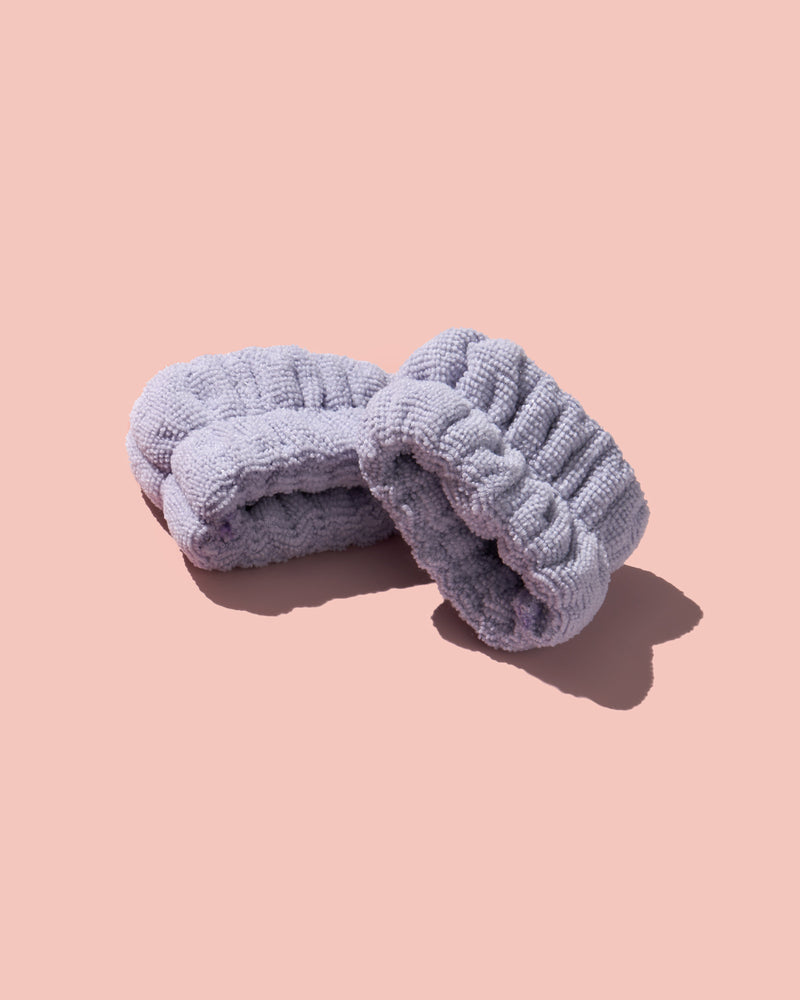 Fenty Skin Purple Cleansing Cuffs on a pink background.