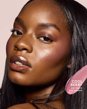 deep skin toned model wearing cheeks out freestyle cream blush in shade cool berry