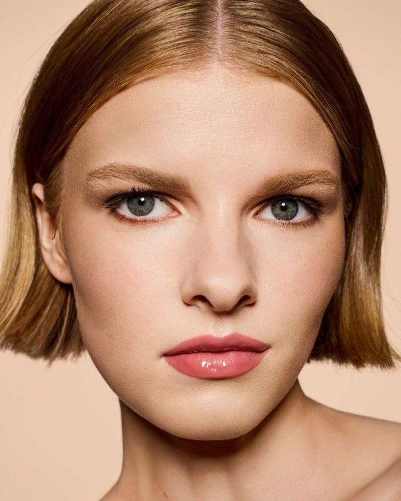 light skin tone model wearing Gloss Bomb Heat Universal Lip Luminizer + Plumper in shade Fu$$y Heat