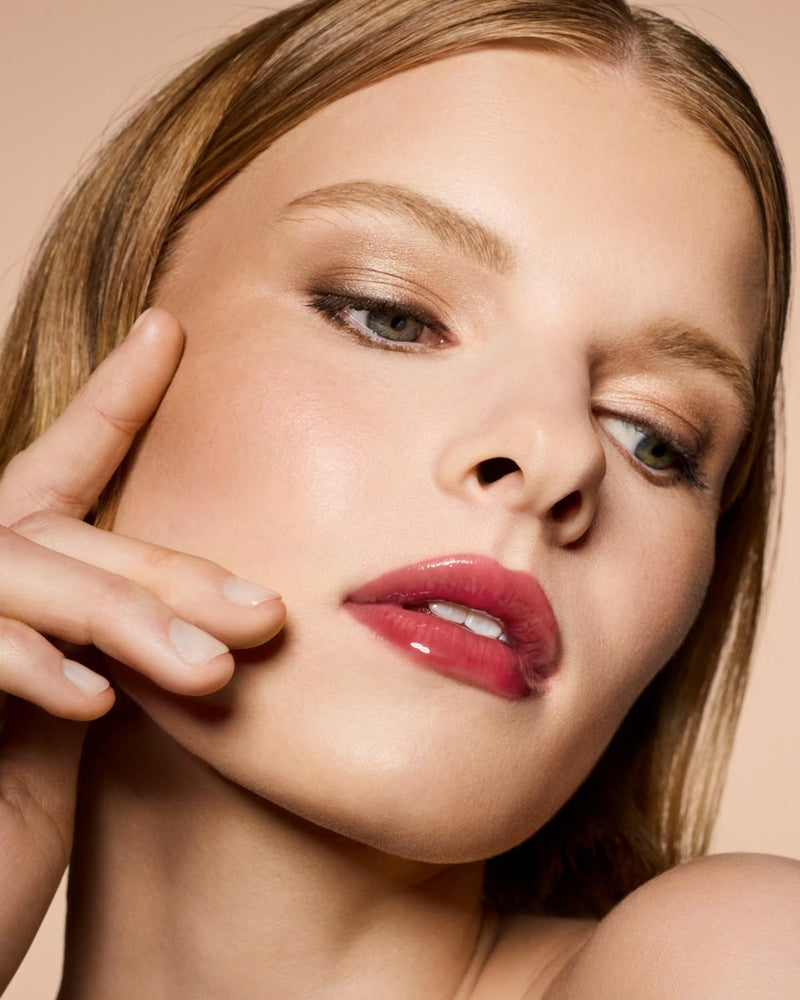 Light skin tone model wearing Gloss Bomb Heat Universal Lip Luminizer + Plumper in shade hot cherry