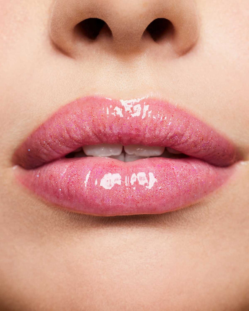 Product shot of Fenty Beauty Gloss Bomb Universal Lip Luminizer and packaging in limited edition Arcane collection shade Rogue on Riches.