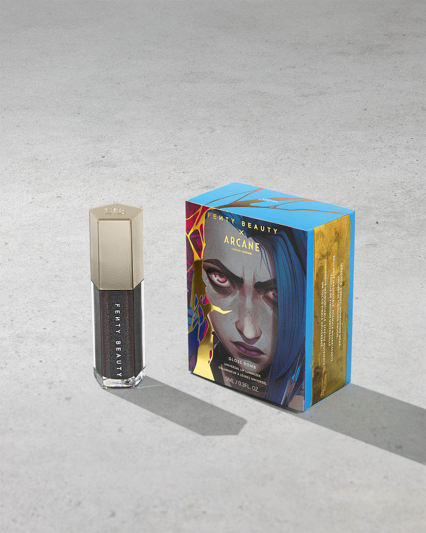 Product shot of Fenty Beauty Gloss Bomb Universal Lip Luminizer and packaging in limited edition Arcane collection shade Kaboom. 