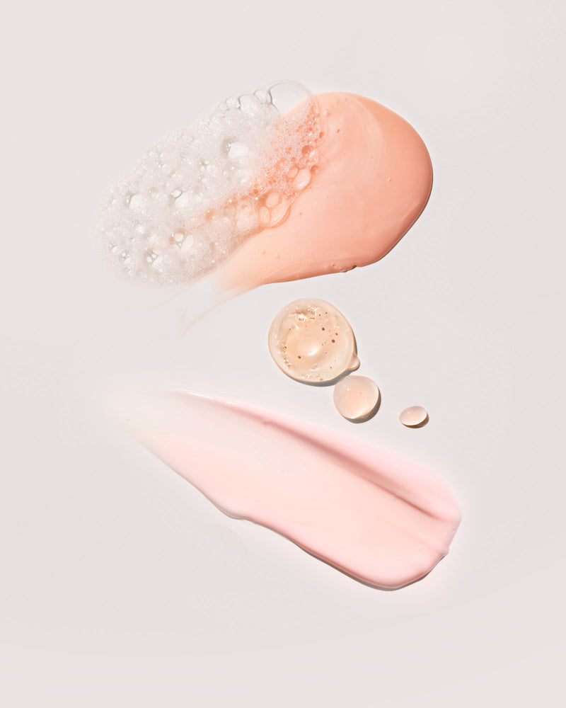 A smear of each product in the Fenty Mineral Skin Start'r Set full-size bundle on a peach background.