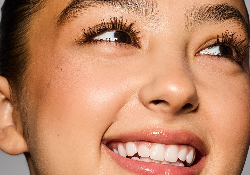 Model wearing Hella Thicc Mascara over Hella Extra Mascara Primer.