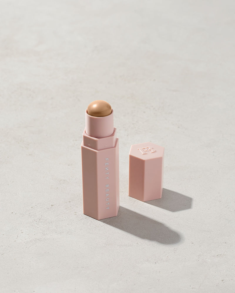 Match Stix Contour Skinstick shown in shade Soft Amber on a concrete background. 