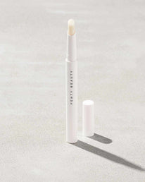 Brow MVP Sculpting Wax Pencil standing upright with the cap off and the brow wax twisted up.