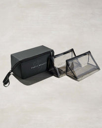 One black rectangular and two triangular clear bags with Fenty branding on a gray background