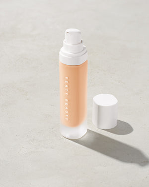 open bottle of Fenty Beauty Pro Filt'r Soft Matte Longwear Foundation with pump dispenser in shade #120 on concrete background
