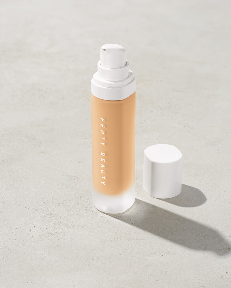 open bottle of Fenty Beauty Pro Filt'r Soft Matte Longwear Foundation with pump dispenser in shade #190 on concrete background