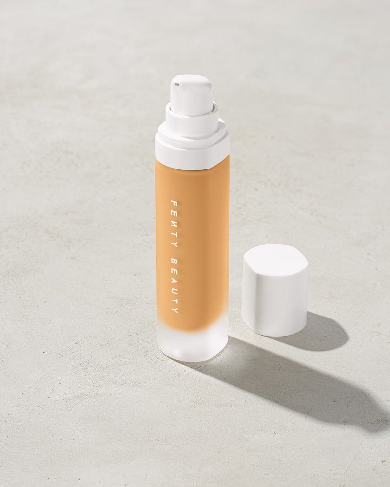 open bottle of Fenty Beauty Pro Filt'r Soft Matte Longwear Foundation with pump dispenser in shade #250 on concrete background