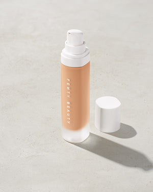 open bottle of Fenty Beauty Pro Filt'r Soft Matte Longwear Foundation with pump dispenser in shade #260 on concrete background