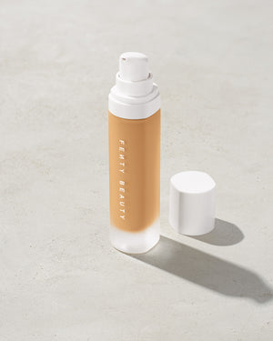 open bottle of Fenty Beauty Pro Filt'r Soft Matte Longwear Foundation with pump dispenser in shade #290 on concrete background
