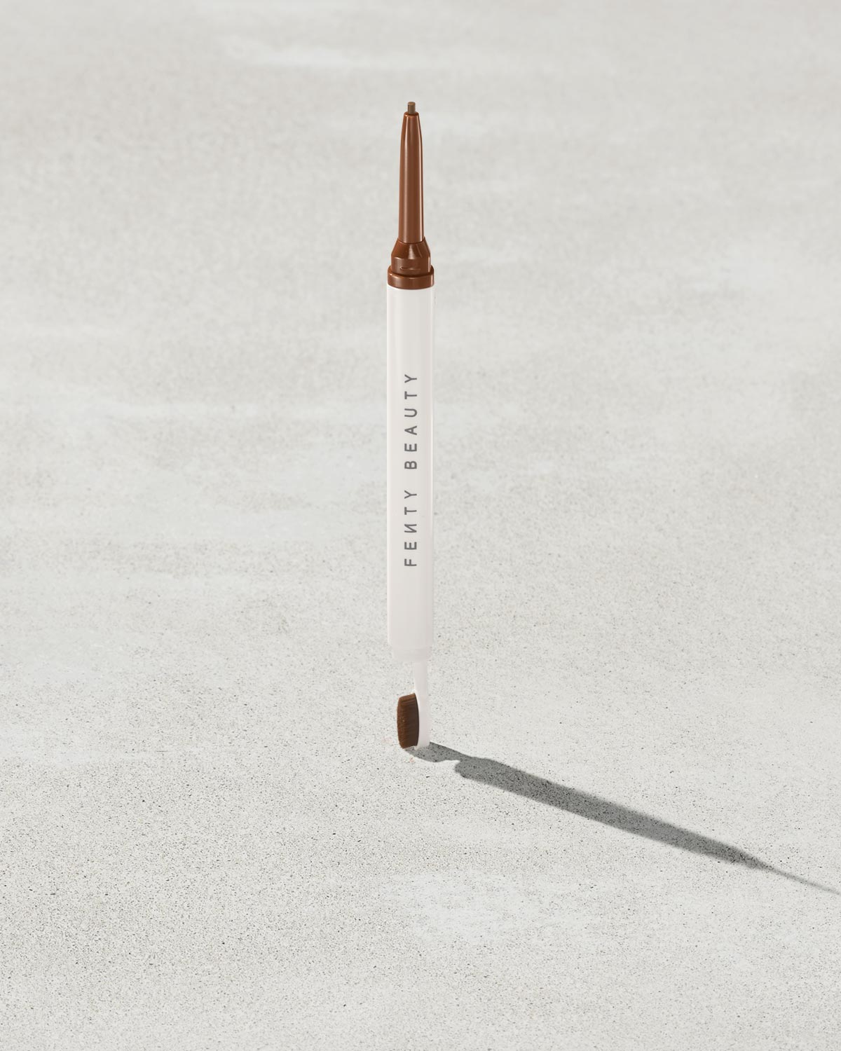 Brow MVP Sculpting Wax Pencil standing upright with the cap off and the brow wax twisted up.