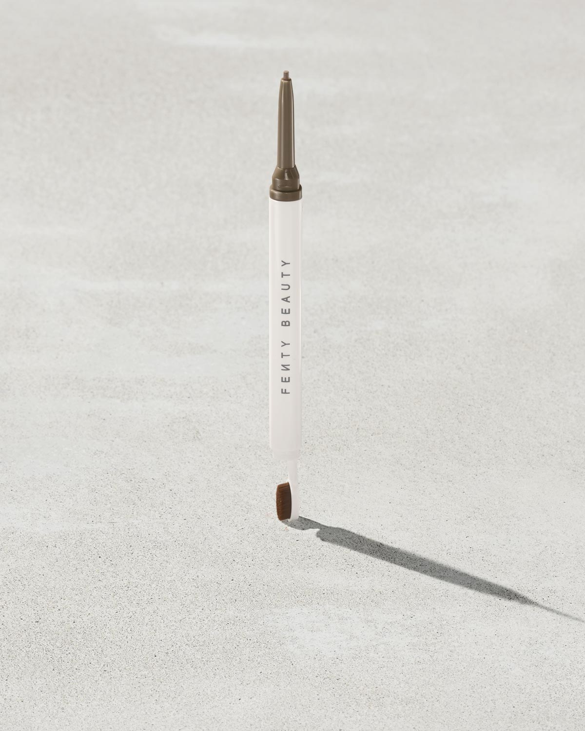Brow MVP Sculpting Wax Pencil standing upright with the cap off and the brow wax twisted up.