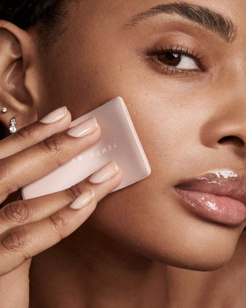 Close-up of model Alex applying Invisimatte Instante Setting Blotting Powder with a sponge