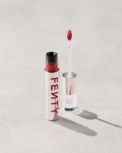 An open Fenty Icon Velvet lipstick tube on a light background.