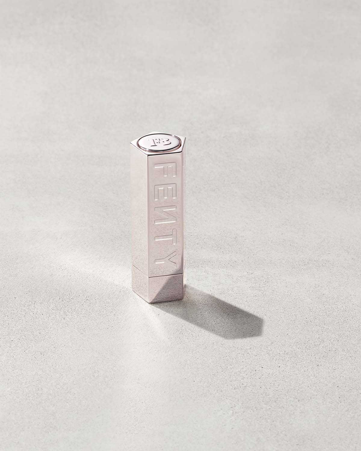 A Fenty Icon metallic refillable lipstick case.