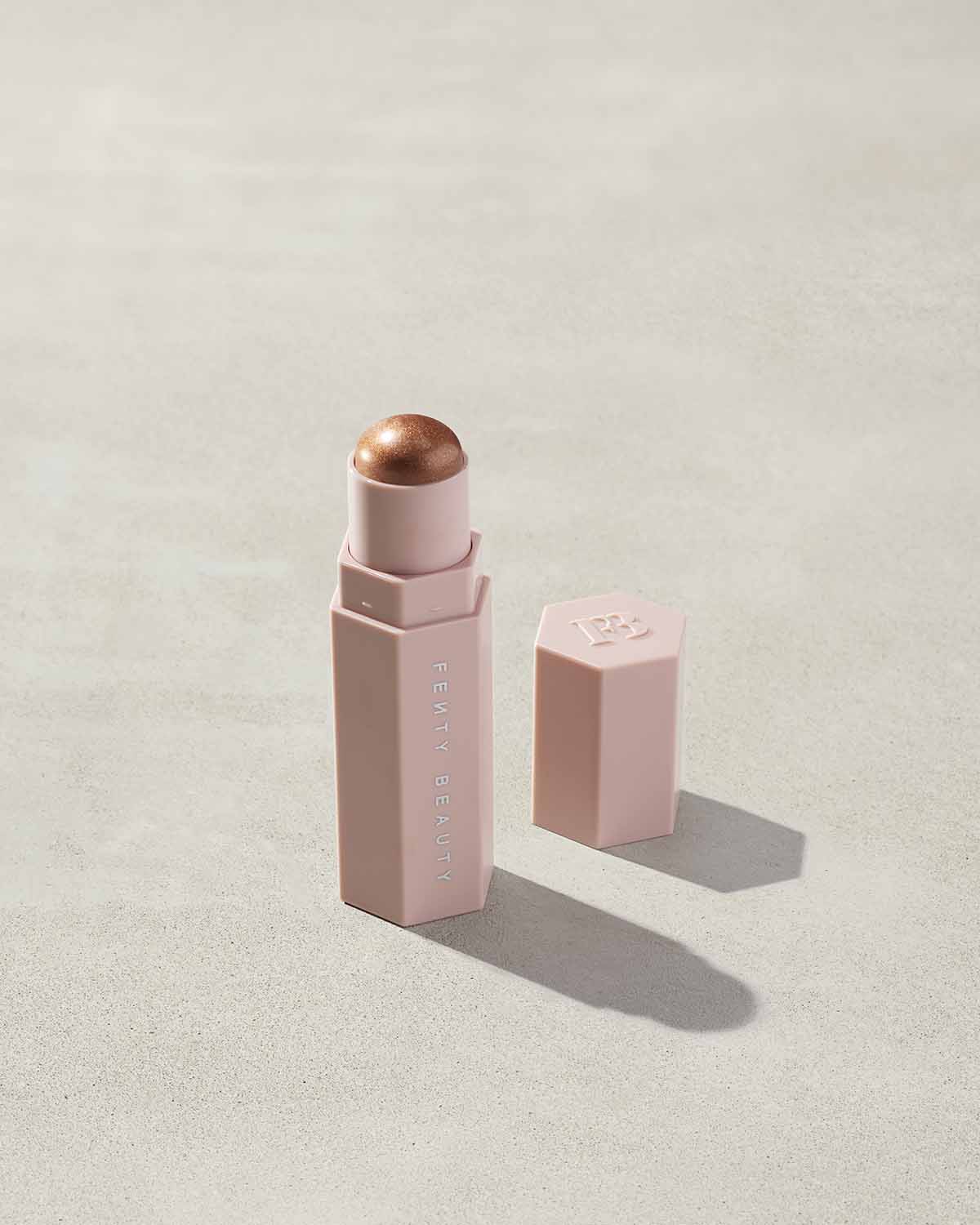 Match Stix Shimmer Skinstick shown in shade Truffle Spark on a concrete background. 