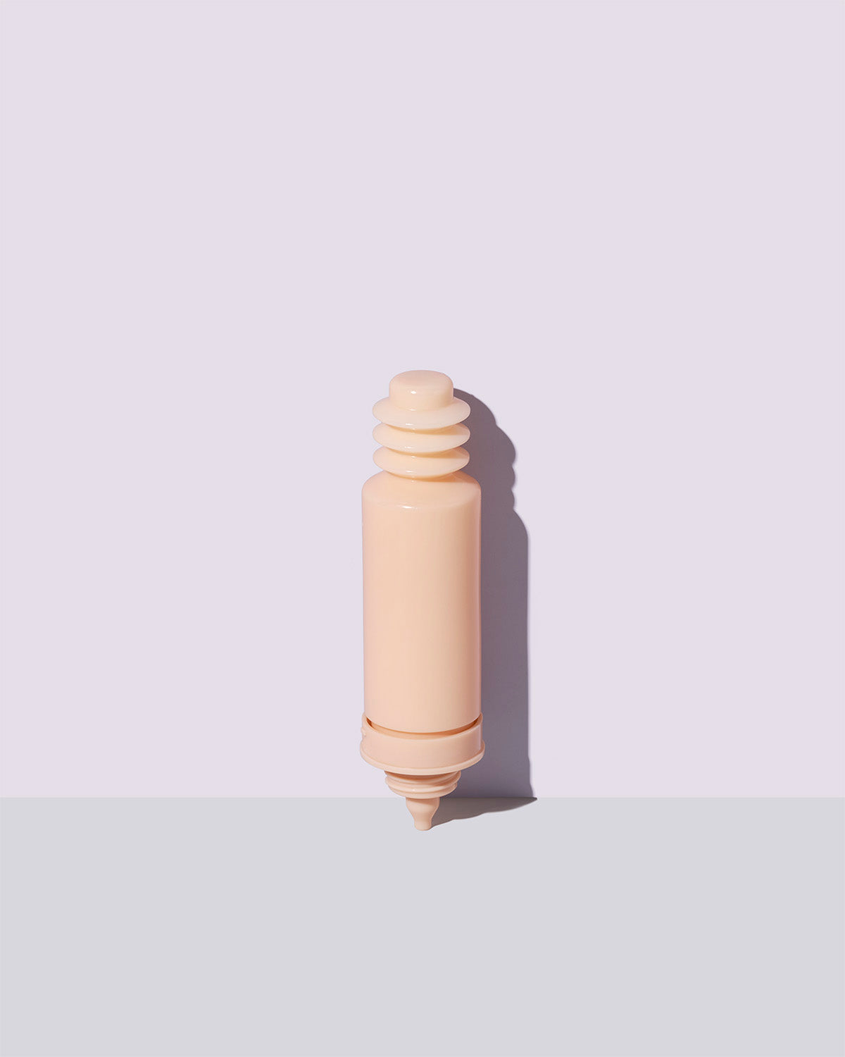 Container of the refill for the Watch Ya Tone Niacinamide Serum on a lilac background.